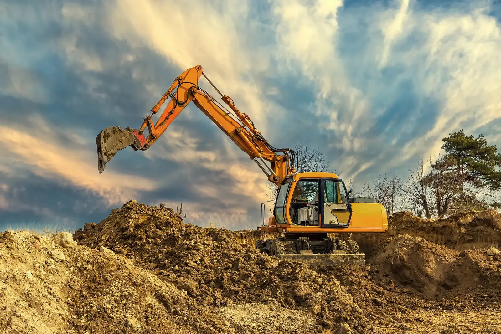 Shamrock excavator opening a trench to reach a broken underground line