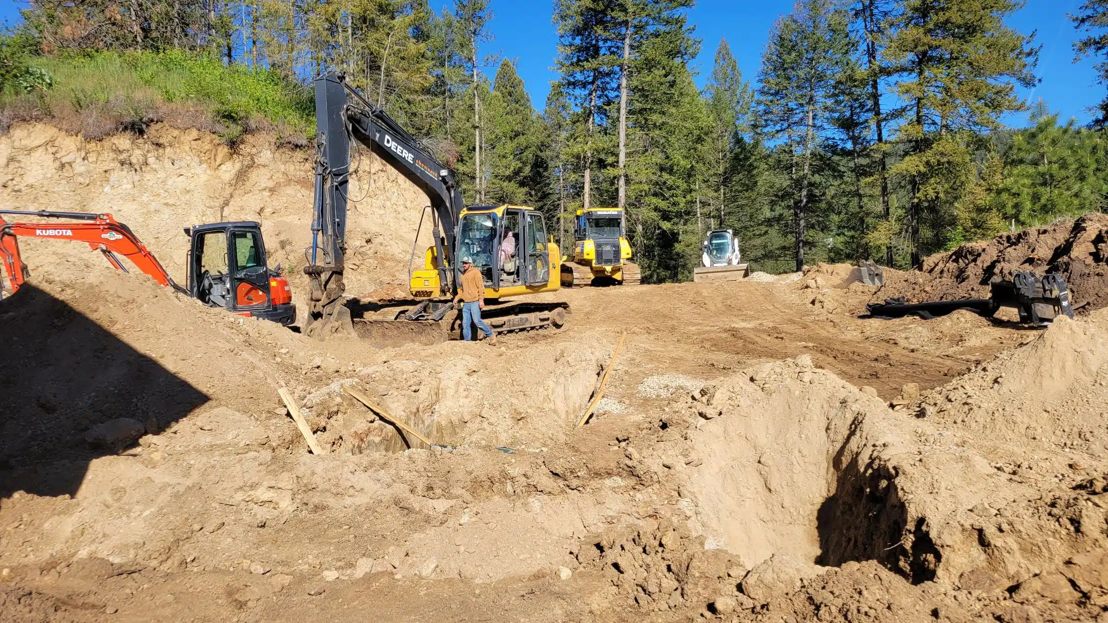 Excavator loading a dump truck during site work near Boise