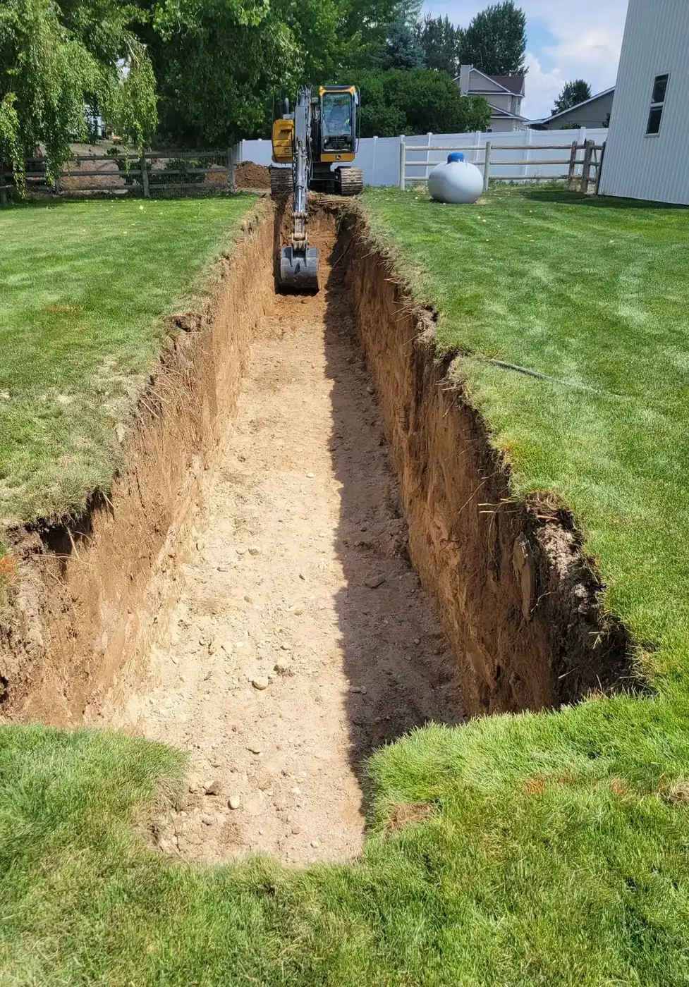 Shamrock crew exposing a failed sewer line in a Boise backyard during an emergency repair