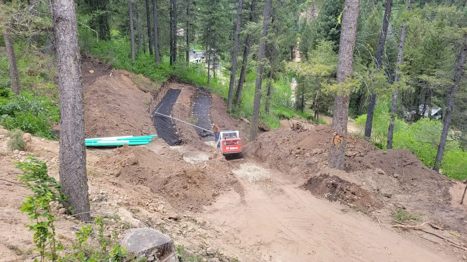 Septic system installation with excavator on a rural Idaho property