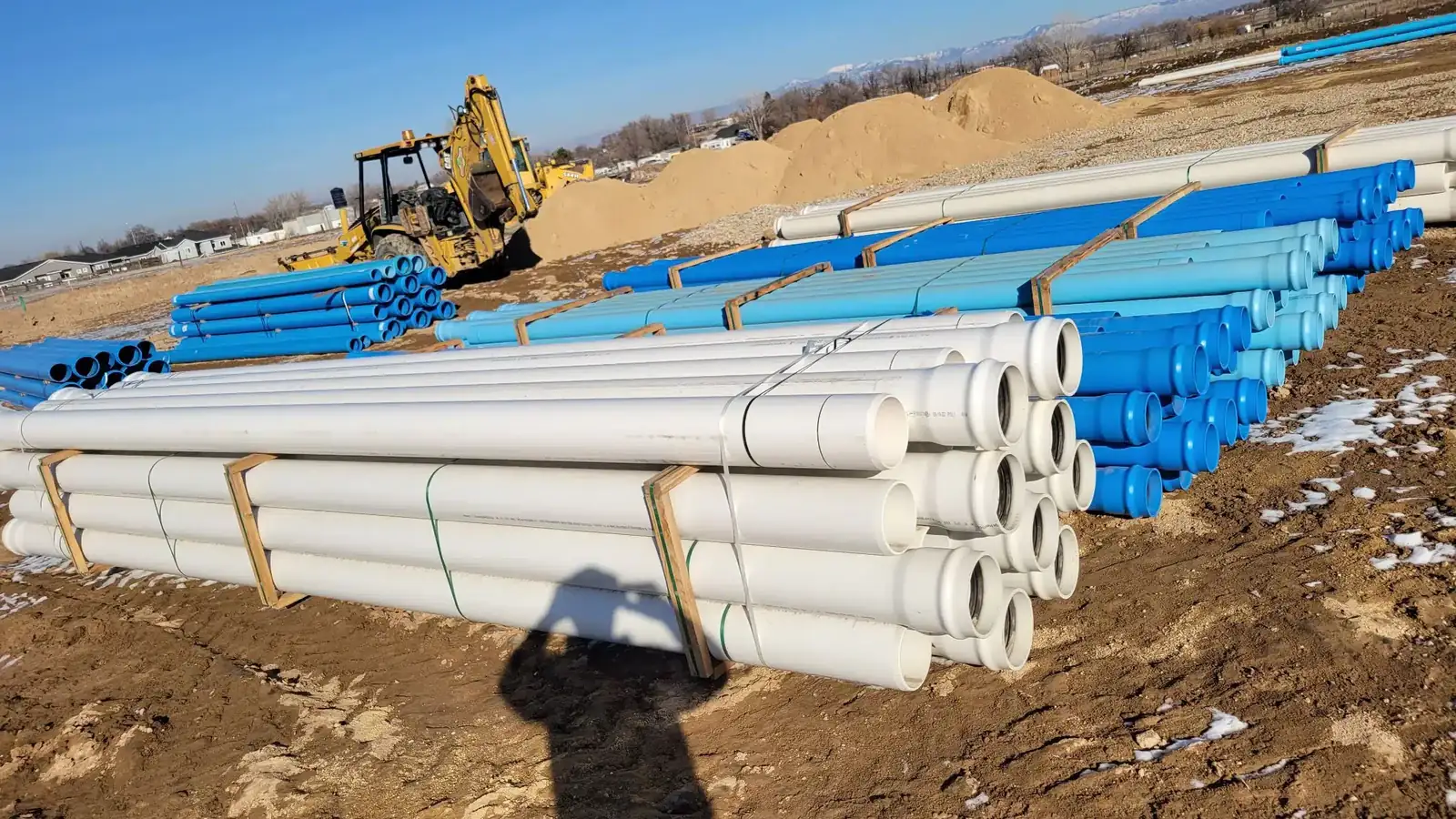Sewer line excavation with equipment staged on site near Boise