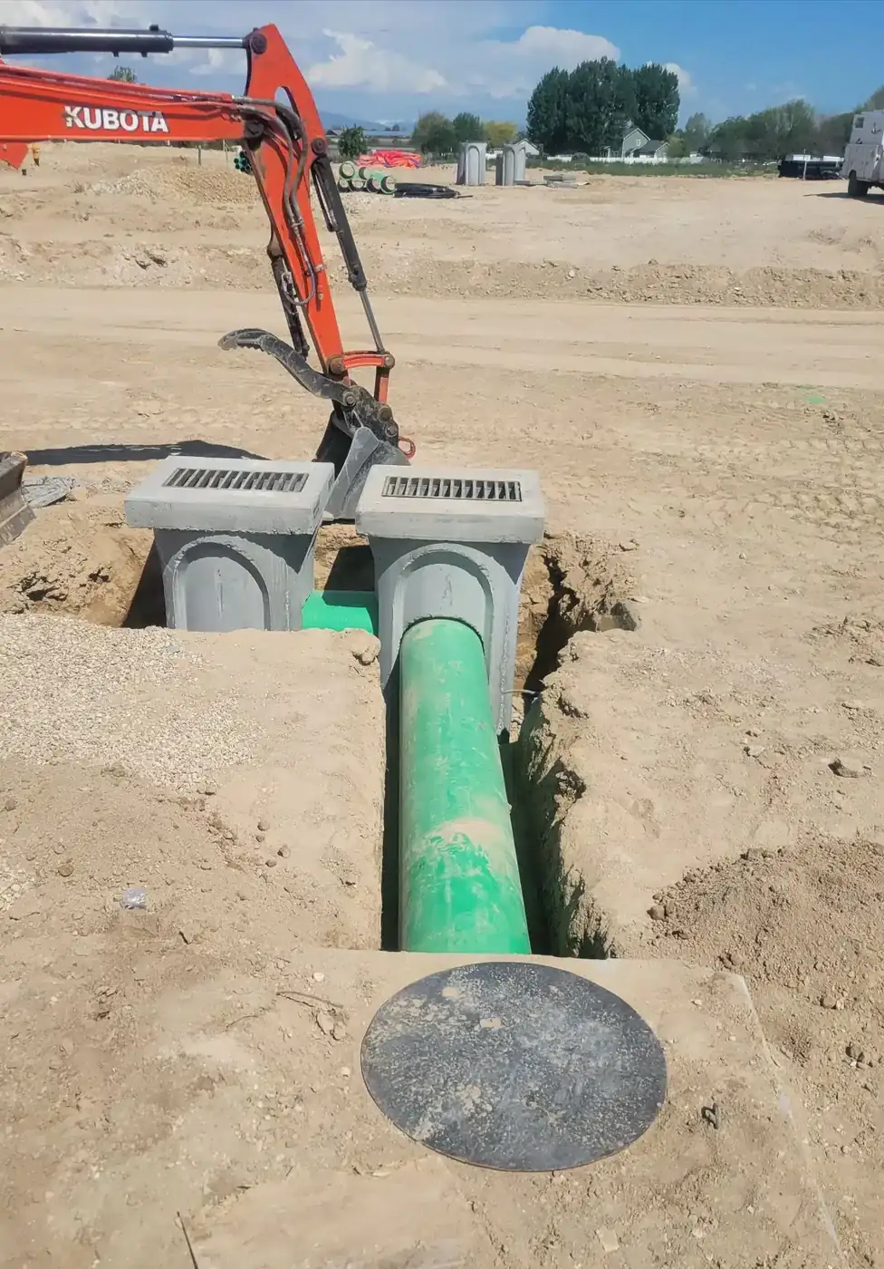 Crew installing a new sewer line in an excavated trench near Boise, Idaho