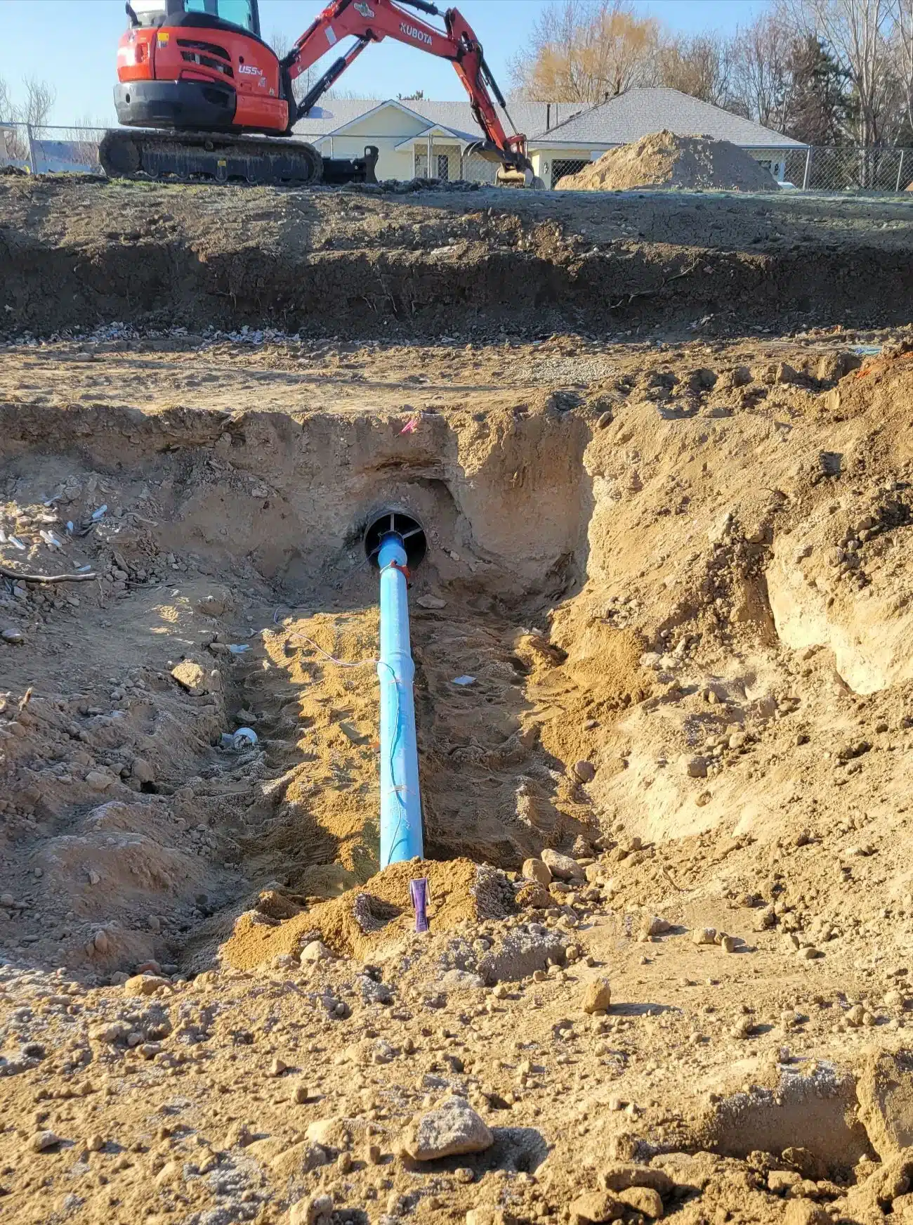 Water line repair excavation exposing the service line on a Boise property