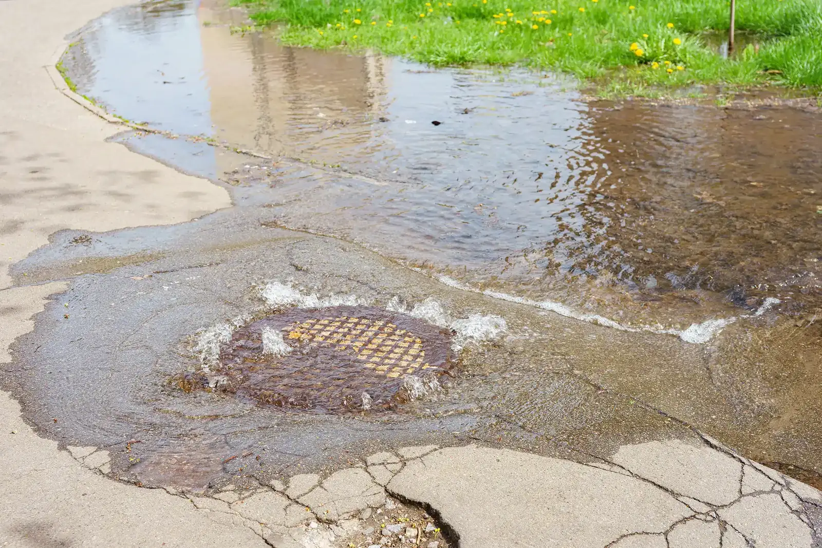 Water surging out of a sewer manhole during an underground line failure
